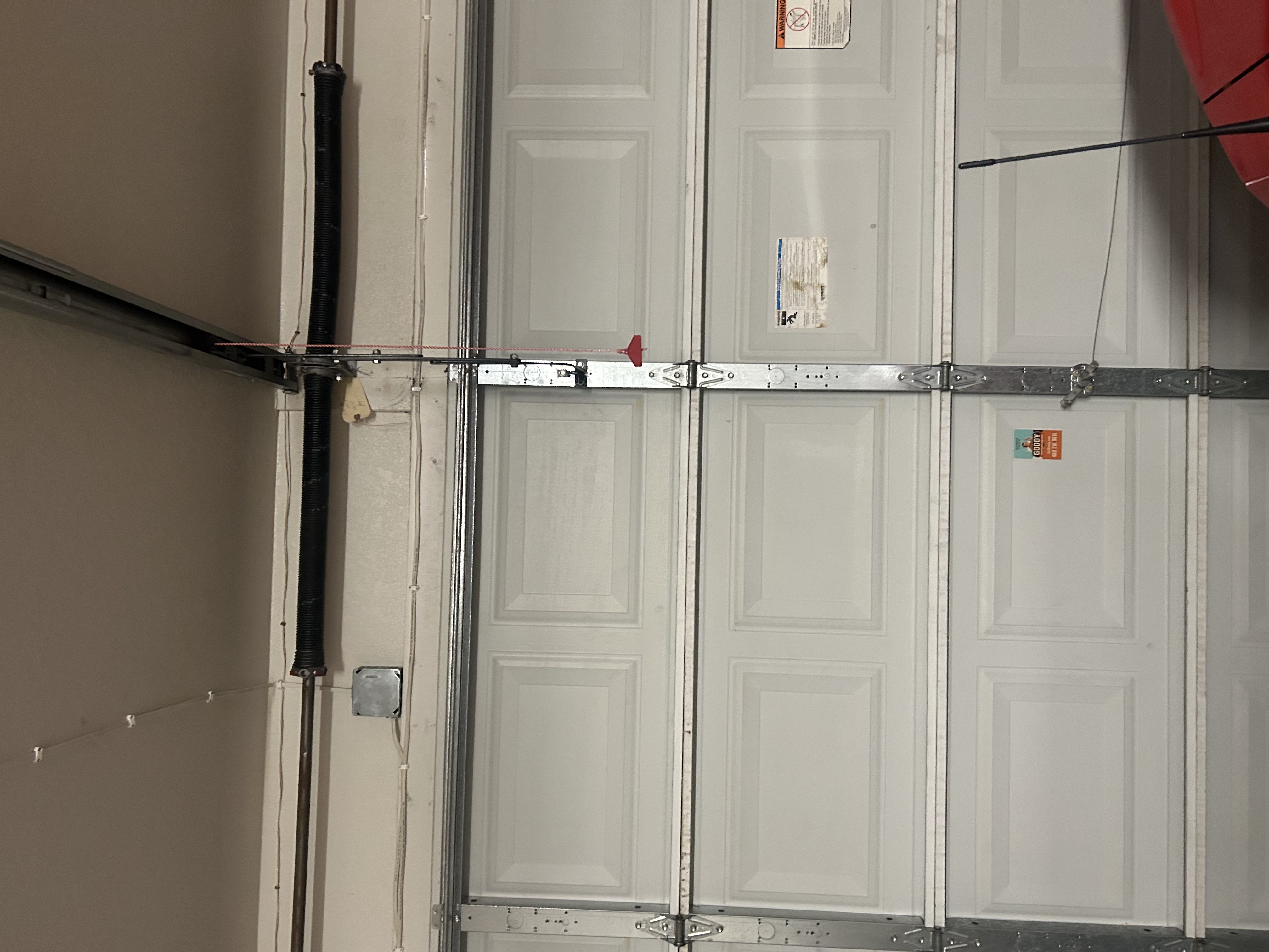 Ceiling-mounted garage door opener and track inside a Phoenix garage.