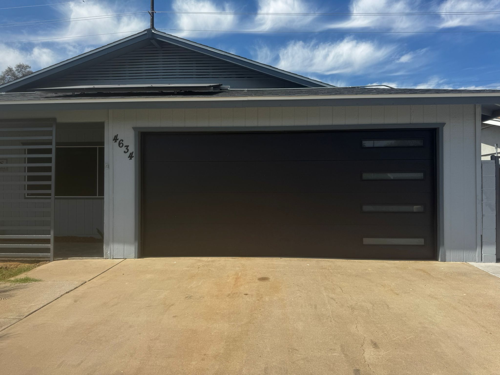Completed modern black garage door replacement on a Phoenix home.